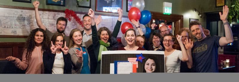 A group of volunteers cheer for candidate Manka Dinghra in Oregon