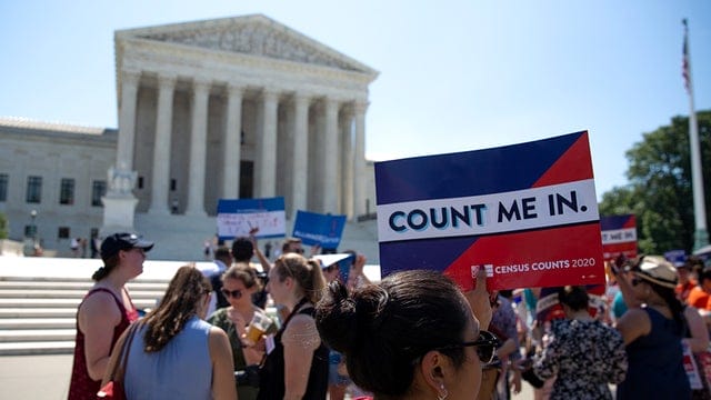 Protesters hold signs outside the Supreme Court