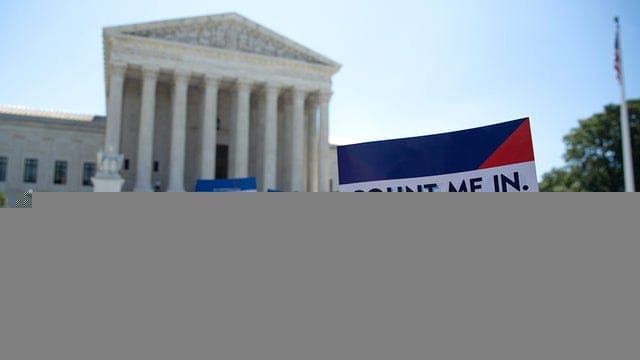 Protesters hold signs outside the Supreme Court