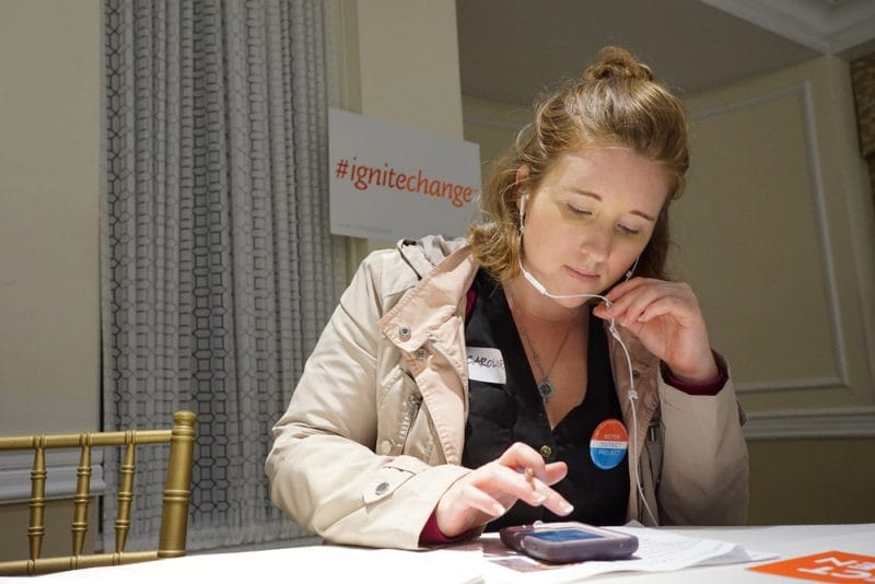 Woman volunteer for Sister District and EMILY'S LIST with headphones in her ears, phonebanking for Democratic candidates