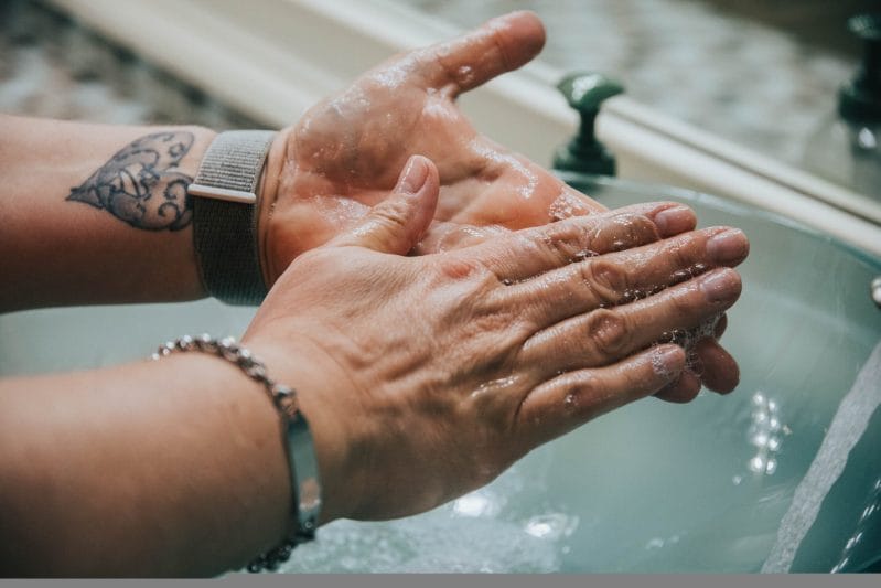 Person washing hands with soap